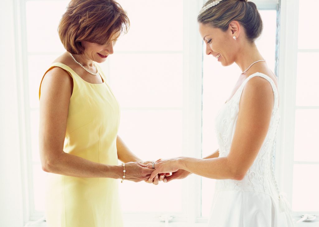 portrait of a bride and her mother adjusting a ring