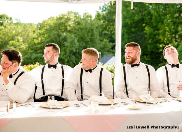 photo of five groomsmen laughing at a dining table